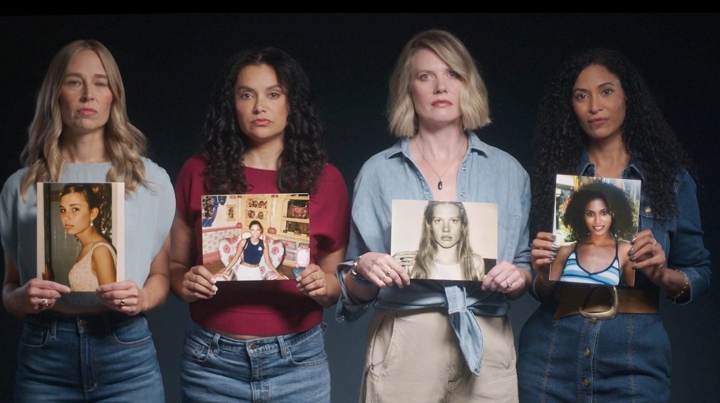 Picture of four Epstein survivors holding a picture of when they were children and abused.